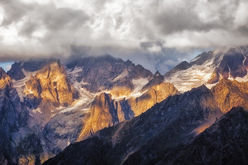 Fototapeta na wymiar Detail of dramatic mountain range with colorful sunlight, Svaneti, Georgia
