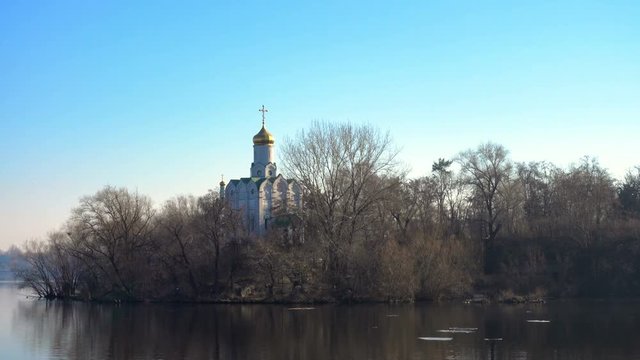ortodox church on a river bank at the sunny spring day