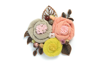 Brooch handmade from a fabric consisting of three flowers of gray, pink and yellow colors