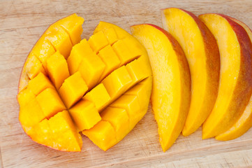 Mango sliced lying on a wooden board