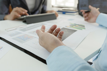 Investor executive discussing plan financial graph data on office table with laptop and tablet, finance, accounting, investment, meeting.
