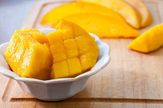 Small plate with mango on a wooden board