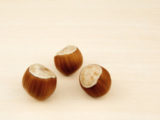Hazelnuts on a wooden background closeup.