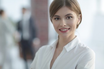 portrait of young business woman on the background of the office