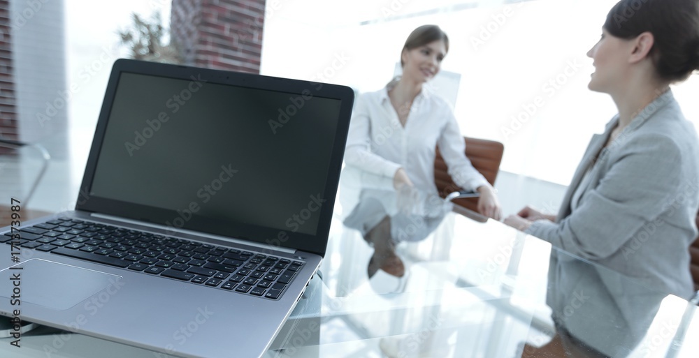 Poster laptop and a smartphone on the desktop of a businessman