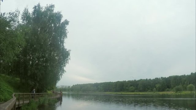Cloudy Day In Park On Shore Of The Pond Timelapse
