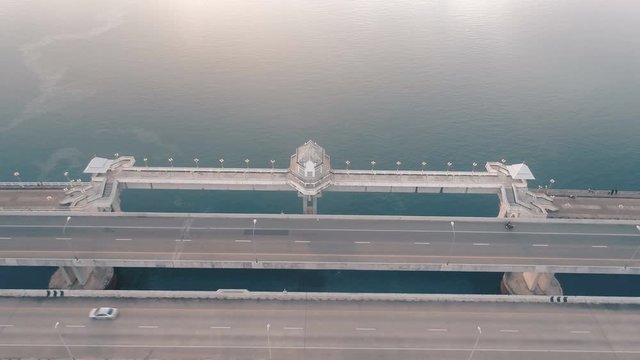 Aerial drone view of bridge and sea with visible oil leak from an industrial boat