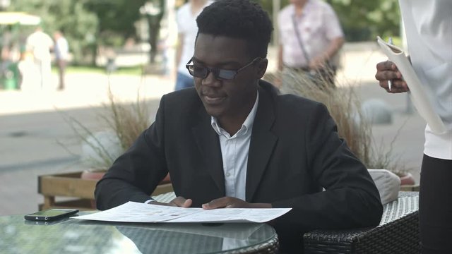 Afro american businessman during work break take an order in restaurant