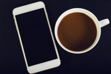 Fototapeta na wymiar Coffee and smartphone on wooden background.