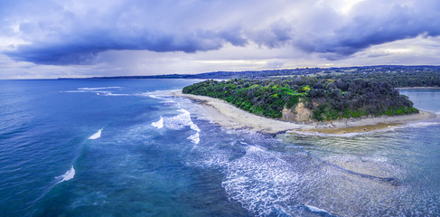 Aerial panoramic landscape of storm clouds over ocean coastline