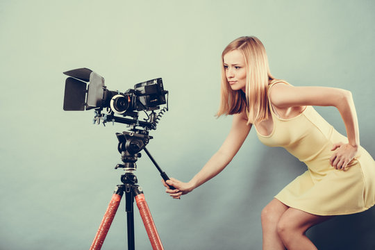 Photographer woman with camera taking photos