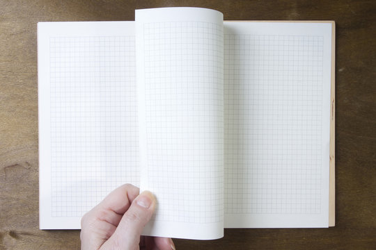 Hands turn pages of the notebook - Powered by Adobe