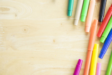 Fototapeta premium Colorful pen on wooden table background with space.