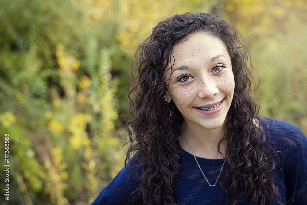 Wall mural beautiful hispanic teen girl portrait with braces on her teeth