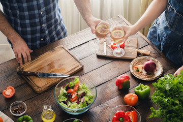 Couple cooking together delicious and healthy dinner and drinks wine
