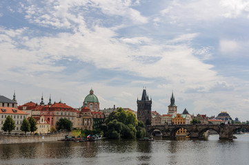 Cityscape view on the riverside with the bridge and old town in Prague