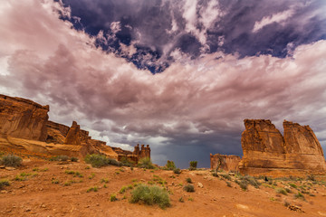 Dramatic storm clouds in Arches National Park and red sandstone formations