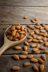 Almonds pour from wood spoon