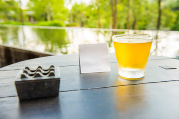Relax time with glass of beer at natural resort.