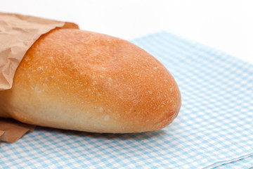 french bread with paper bag on white background