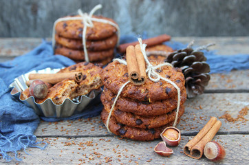 oatmeal cookies and hazelnuts on a wooden background.