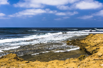 Fototapeta na wymiar Surf on the coast of the Akamas Peninsula
