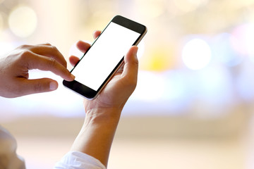 Man hands holding blank screen smartphone in Co-working or cafe.