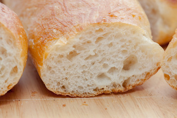 a slice of french bread on wooden plate