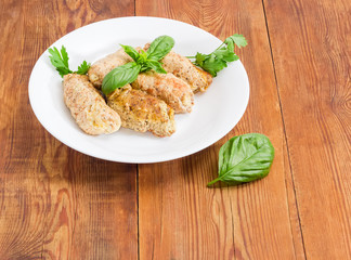 Meat roulades with filling on a white dish