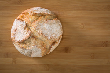 Baked bread on wooden background