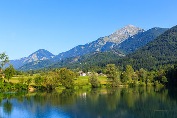 Fototapeta na wymiar Lake Črnava (Jezero Črnava) in Slovenia. The highest mountaun in background is Storžič. Summer 2017.