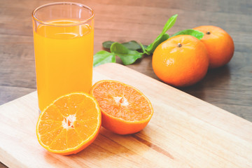 Orange juice with fresh oranges on wood table, Autumn and fall season