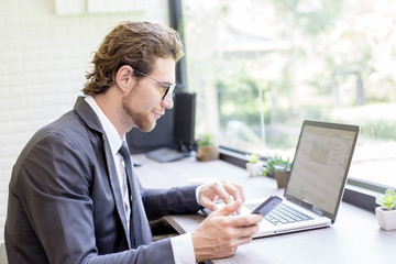 Businessman using laptop for work with smiling. Businessman working concept.
