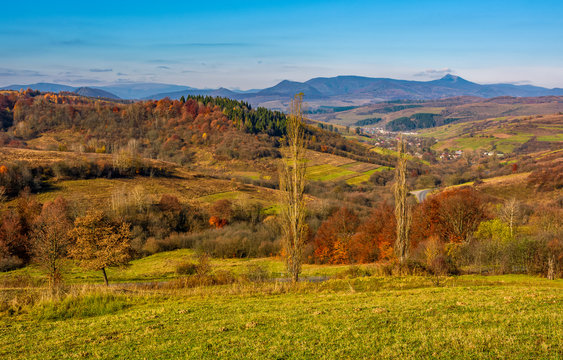 rural grassy fields on hills in gorgeous mountains. stunning countryside landscape in autumn