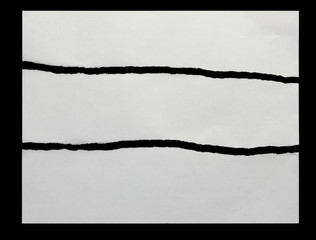three pieces of torn paper on a black background