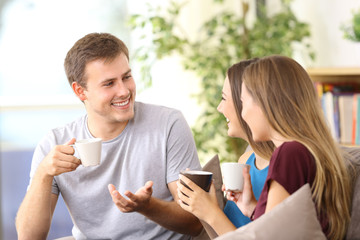 Three cheerful friends talking at home
