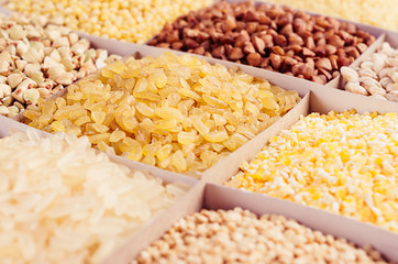 Assortment different groats with blur, closeup. Wheat pearl, bulgur, millet, rice, couscous, semolina, corn grits, buckwheat, quinoa.