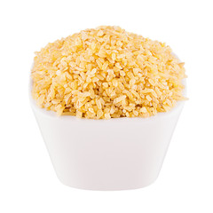 Bulgur groats in white bowl, closeup, isolated. Template for menu, cover, advertising.