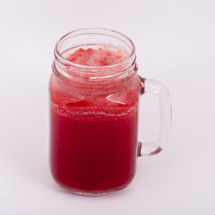 Raspberries juice smoothie shake in glass mug on white background, close up