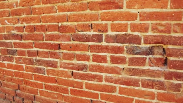 Names Carved In Rustic Historic Red Brick Wall Backdrop