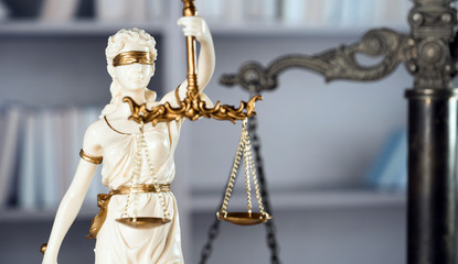 Law symbols on law books background