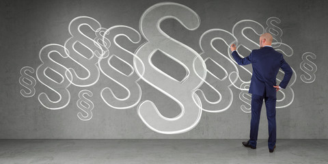 Businessman drawing law paragraph symbol on a wall 3D rendering