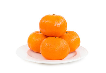 Fresh tangerines (mandarin oranges) in pile of four pieces on white plate isolated on white background (Clipping Path included) to celebrate Chinese new year or special holy occasions