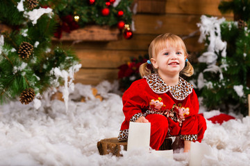 happy little christmas girl, Beautiful little girl blowing snowflakes in white winter forest...