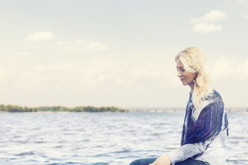 Fototapeta premium Blonde funny happy pretty romantic woman in the park near river. Sunny day.