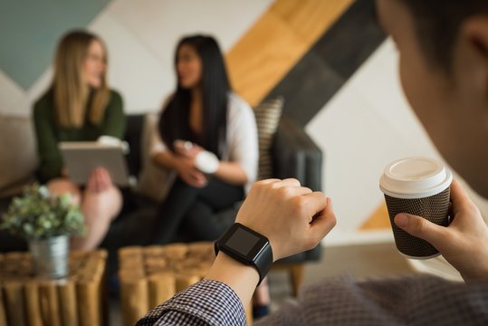 Businessman checking time in office