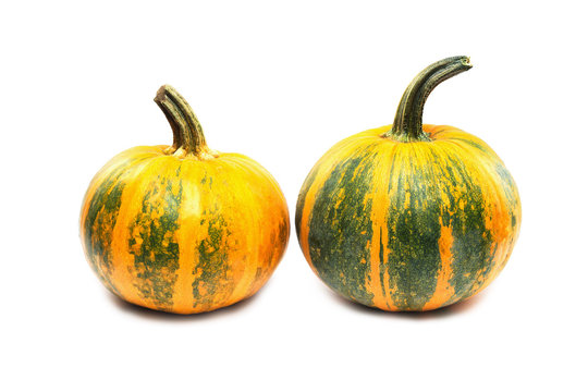 Two orange and green pumpkins with clipping path isolated at white background.