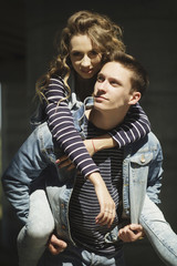 Young beautiful fashion couple wearing jeans clothes in daylight. Love concept.