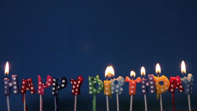 lighted candles on a birthday of sake on a purple background