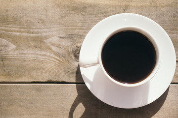 White cap of coffee on the wood background. By Letowa.